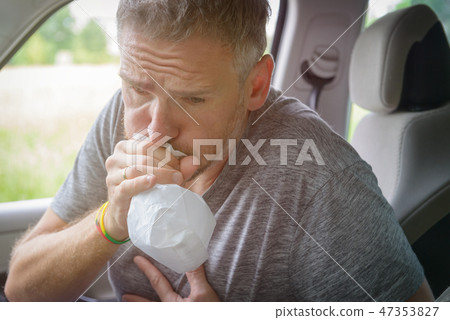 Man suffering from motion sickness Man suffering from motion sickness 47353827