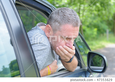 Man suffering from motion sickness Man suffering from motion sickness 47353829