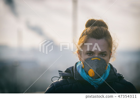 Wearing a real anti-pollution, anti-smog face mask 47354311