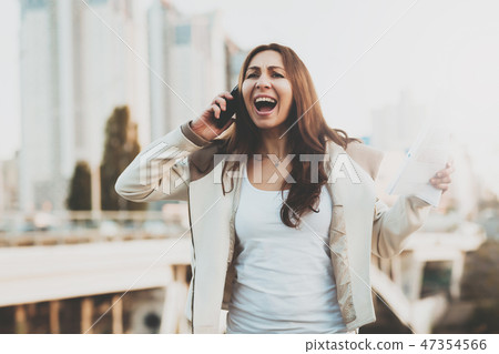 Girl on phone with buildings on background. Girl on phone with buildings on background. 47354566