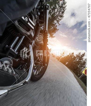 Detail of motorcycle driving in Alpine road 47354707