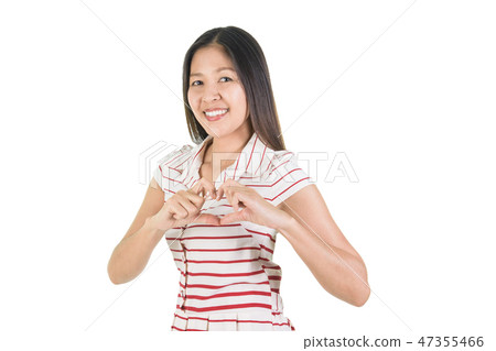 Happy smiling  young woman making heart shape. 47355466