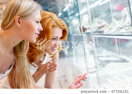 Two Girl Are Looking at Jewelry Shop Display Window Two Girl Are Looking at Jewelry Shop Display Window 47356281