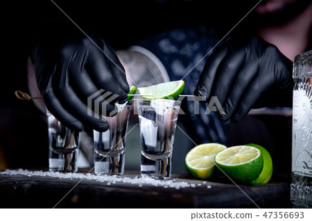 aperitif with friends in the bar, three glasses of alcohol with lime and salt for decoration aperitif with friends in the bar, three glasses of alcohol with lime and salt for decoration 47356693