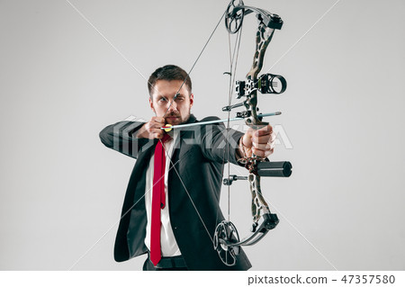 Businessman aiming at target with bow and arrow, isolated on white background 47357580
