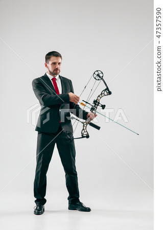 Businessman aiming at target with bow and arrow, isolated on white background Businessman aiming at target with bow and arrow, isolated on white background 47357590