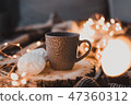 A cup of black tea with white marshmallow. 47360312