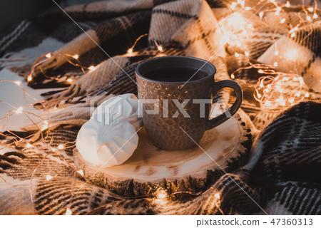 A cup of black tea with white marshmallow. A cup of black tea with white marshmallow. 47360313