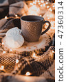 A cup of black tea with white marshmallow. 47360314