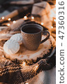 A cup of black tea with white marshmallow. 47360316