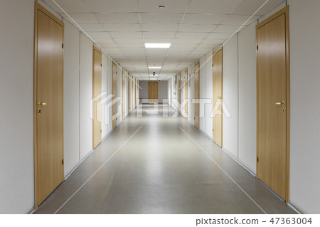 Empty office corridor with many doors of wood. 47363004