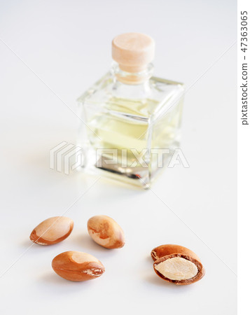 Bottle with valuable oil argan nuts. Cosmetic means. Food product. Jar with argan oil on the Bottle with valuable oil argan nuts. Cosmetic means. Food product. Jar with argan oil on the 47363065