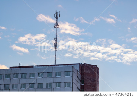 Communication antenna on the roof of a multistory building 47364213