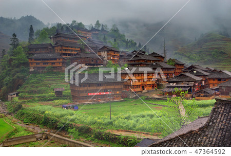 Wooden houses mountainous Chinese village, cloudy Wooden houses mountainous Chinese village, cloudy 47364592
