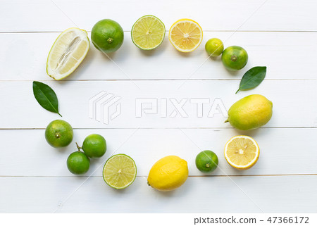 Ripe lemons and limes on white wooden. Ripe lemons and limes on white wooden. 47366172