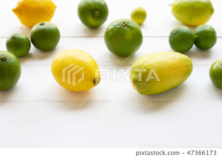 Ripe lemons and limes on white wooden. Ripe lemons and limes on white wooden. 47366173