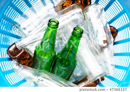 Glass bottles in waste basket. Glass bottles in waste basket. 47366187
