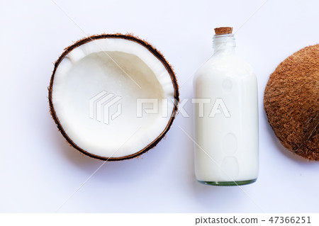 Coconut with coconut milk on white . 47366251