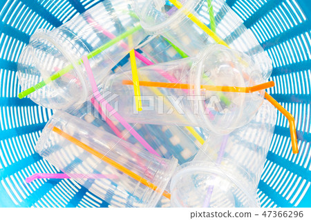 Plastic cups with straws in waste basket. Plastic cups with straws in waste basket. 47366296