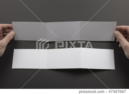 Mens hands holding white booklet Mens hands holding white booklet 47367067