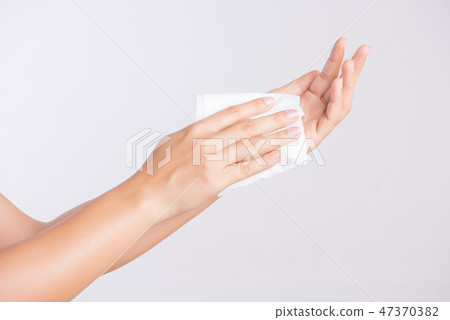 Woman cleaning her hands with a tissue. 47370382