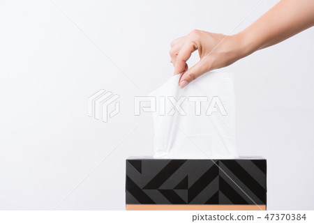 Woman hand picking white tissue paper from box 47370384