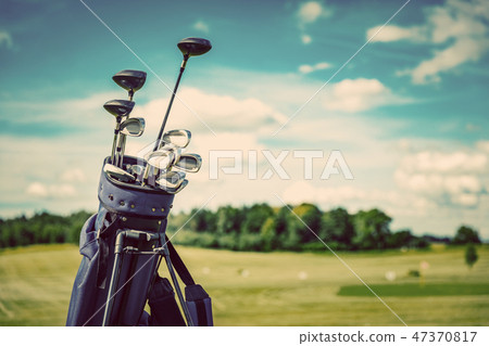 Golf equipment bag standing on a course. Golf equipment bag standing on a course. 47370817