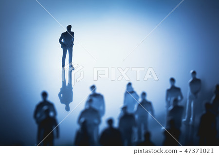 Single man standing in front of group of people. Single man standing in front of group of people. 47371021