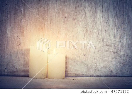 Chistmas candle glowing on rustic wooden wall background. Chistmas candle glowing on rustic wooden wall background. 47371152