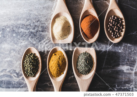 Six wooden spoons with colorful spices 47371503