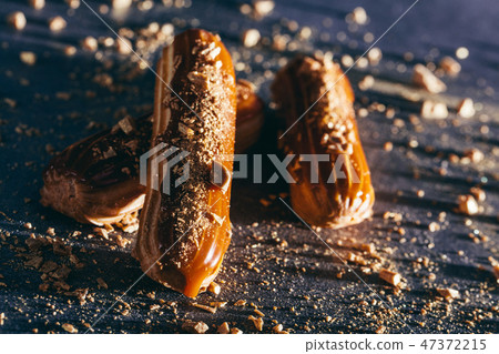 Delicious caramel cakes on dark background. 47372215