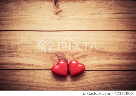 A couple of red little hearts on wood. Vintage concept of love, Valentine's Day A couple of red little hearts on wood. Vintage concept of love, Valentine's Day 47373000