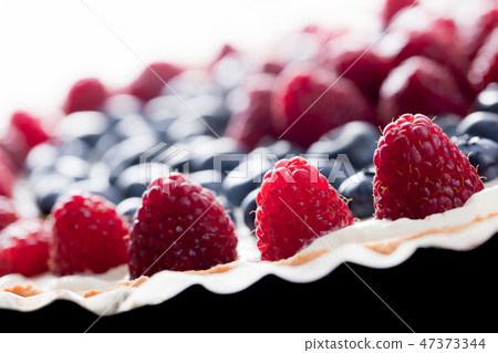 Fruit tart with fresh raspberry and blueberry. Morning light 47373344