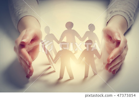 Paper people surrounded by hands in gesture of protection. Concept of insurance 47373854