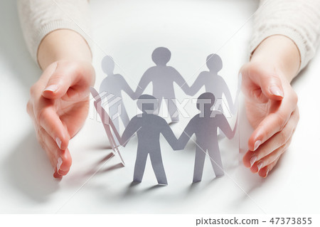 Paper people surrounded by hands in gesture of protection. Concept of insurance 47373855