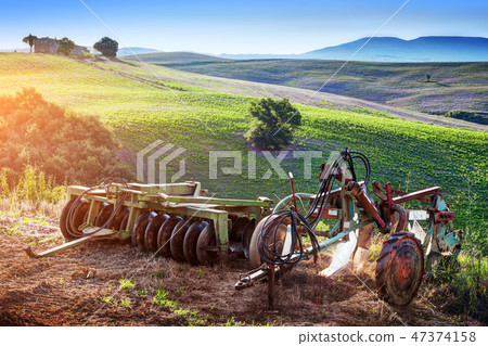 Tuscany landscape at sunrise. Retro agriculture machines. Italy Tuscany landscape at sunrise. Retro agriculture machines. Italy 47374158