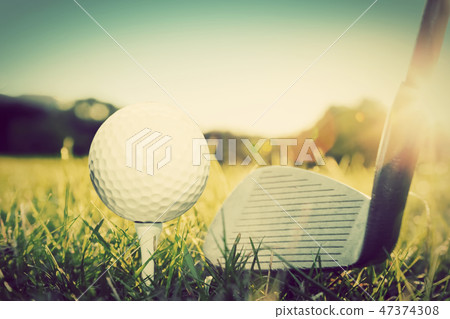 Golf ball on white tee and golf club preparing to shot. Golf ball on white tee and golf club preparing to shot. 47374308