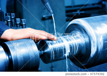 Worker measuring on industrial turning machine. Industry Worker measuring on industrial turning machine. Industry 47374392