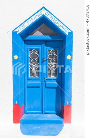 Grunge old blue doors in Oia town, Santorini, Greece. Grunge old blue doors in Oia town, Santorini, Greece. 47375416