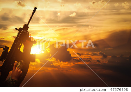 Soldier in combat shooting with his weapon, rifle. War, army concept Soldier in combat shooting with his weapon, rifle. War, army concept 47376598