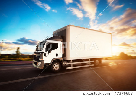 Commercial cargo delivery truck with blank white trailer driving on highway. Commercial cargo delivery truck with blank white trailer driving on highway. 47376698