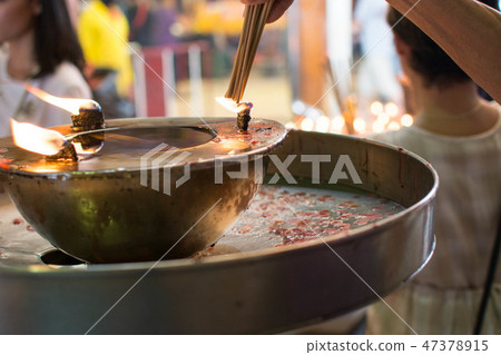 hand cense joss stick to at an incense burne hand cense joss stick to at an incense burne 47378915