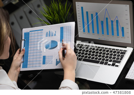 Businessman analyzing investment charts with laptop. Accounting 47381808