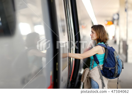 Young woman with backpack take the train. Young woman with backpack take the train. 47384062