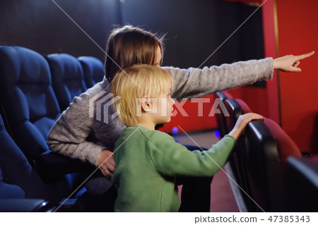 Boy with mother watching cartoon movie in cinema 47385343