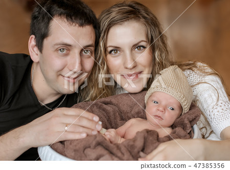 the baby on the hands of parents the baby on the hands of parents 47385356