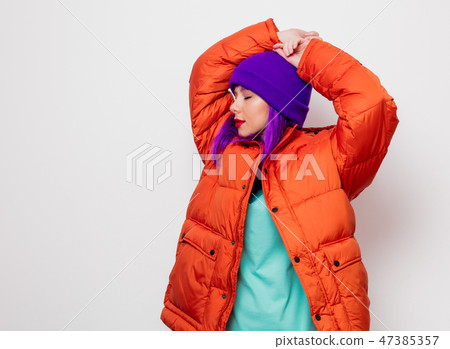 young girl with purple hair and in orange jacket 47385357