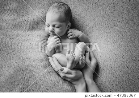 newborn baby lying on the hands of parents newborn baby lying on the hands of parents 47385367