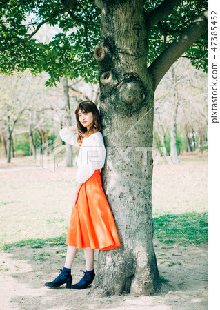 A fresh green tree and a young lady A fresh green tree and a young lady 47385452