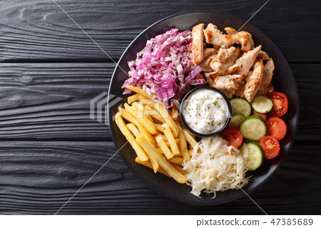 Doner kebab on a plate with french fries, salad 47385689